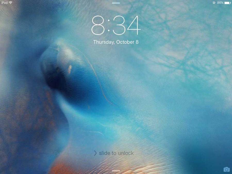 iOS 9 Lock Screen. Here, one can notice the subtle typography changes that come with the new San Francisco font in the clock.