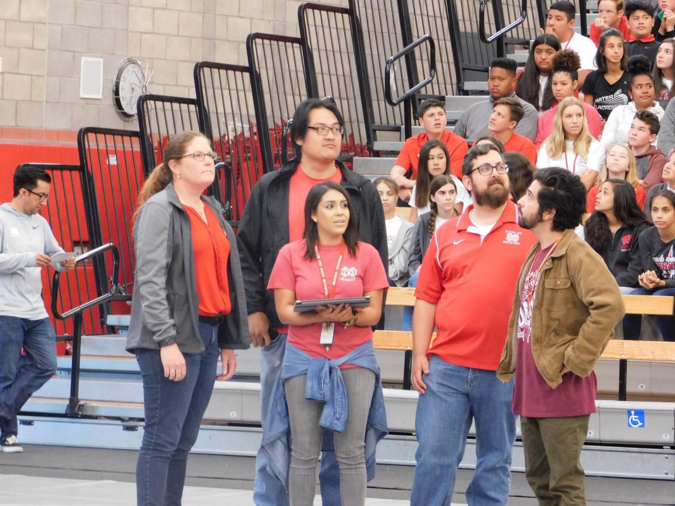 The teachers try to answer the trivia questions in a face to face match against students. 
