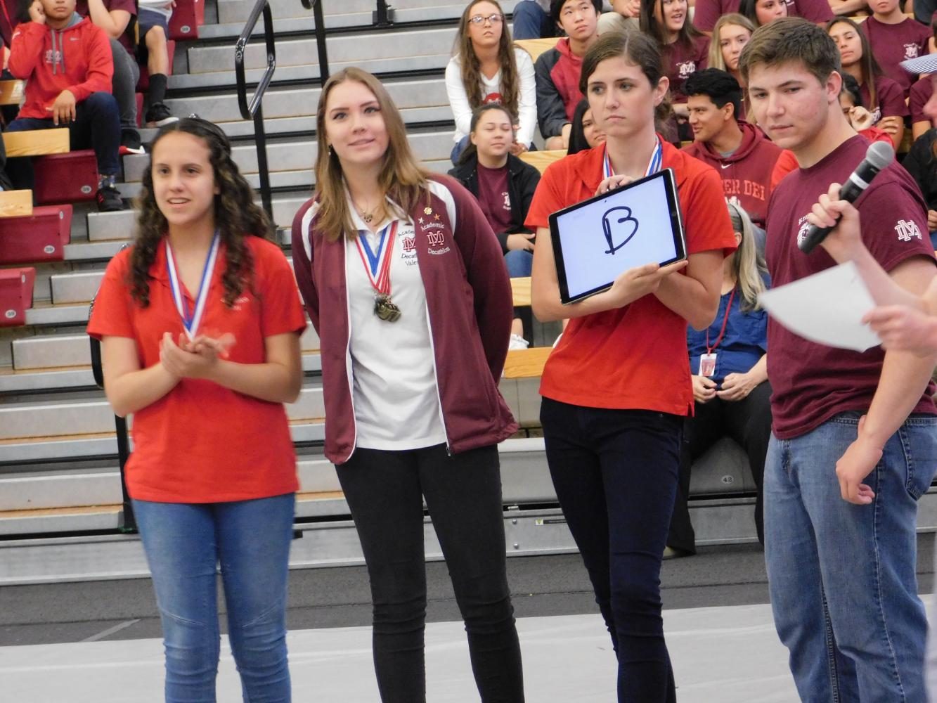 The students compete against the teachers in a trivia game.