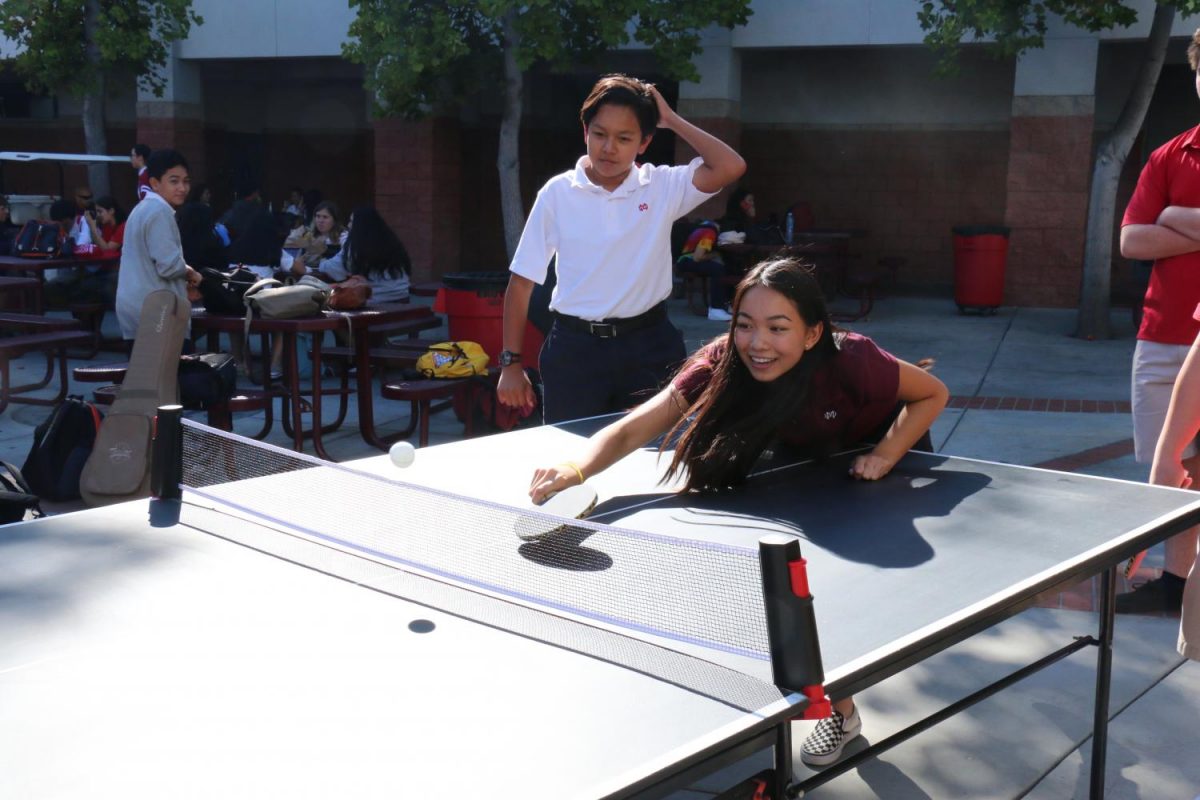 Freshman Teresa Bui plays a competitive game of Ping Pong against her friends. [Ping Pong Club] is a platform for our friends and any student to relax after school by playing ping pong said Yuan. 