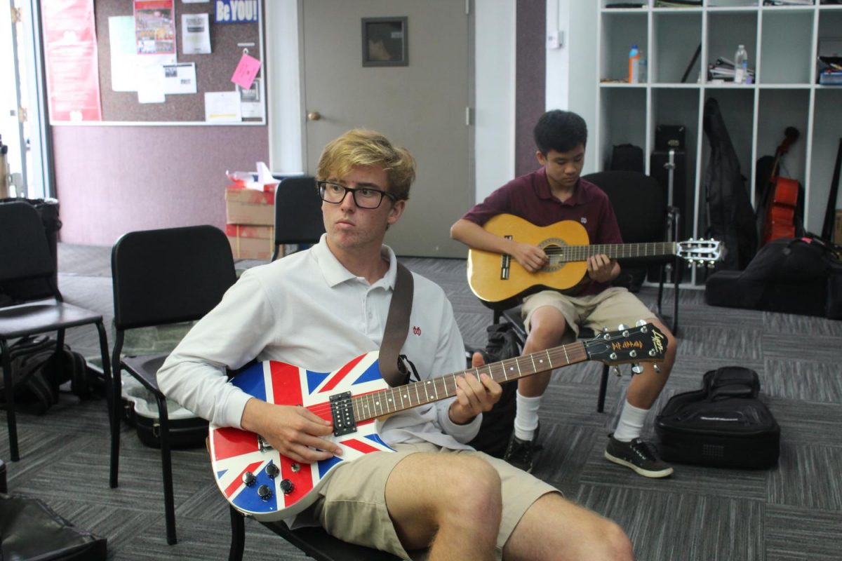 Senior Jake Armstrong practices improvisation and theory in the advanced guitar class.