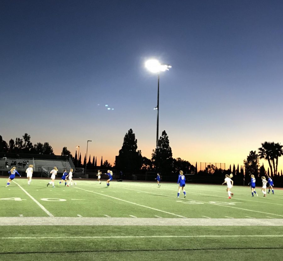 WORKING HARD : As the varsity girls play hard at their tournament in San Diego, defender Jade Harloe clears the ball and the mid get a handle of the ball. When you get the chance to stop a forward from scoring it is an amazing feeling that no one can explain. Harloe said.