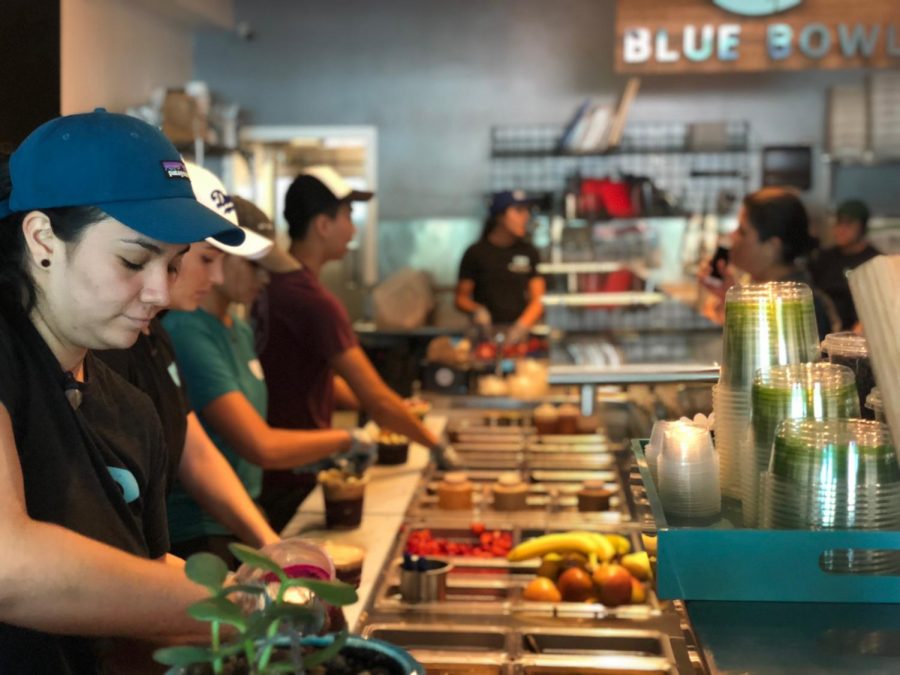 SCOOP THERE IT IS: A Blue Bowl employee scooping pitaya base to prepare a customers personalized bowl. 
