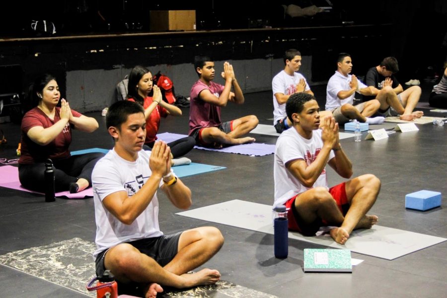 NAMASTE: Sophomore Joshua Hunter and junior Josiah Zamora practice traditional yoga poses in class. The class emphasizes mental wellness and inner peace. “...every time we finish practicing yoga, we end with eight minutes of dead silence, no movement, to reconnect with your breath and relax and take in everything, senior Jeffrey Peterson said. Thats my favorite part.