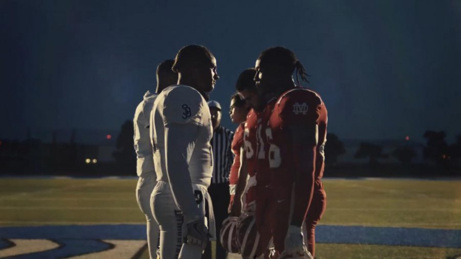 FACE OFF: Actors portraying Mater Deis Monarch football team face off against their rivals, the St. John Bosco Braves, also portrayed by actors. The well-known rivalry was featured in Gatorades recent commercial, which debuted this summer.