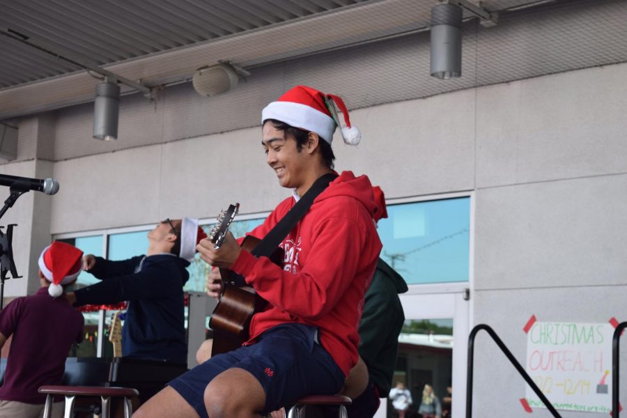 STRUMMING ALL THE WAY: Senior Patrick Pazon smiles as he plays the melody to “Don’t Be Late” from Alvin and the Chipmunks as his fellow classmates sing along. “I’ve always thought guitar was cool,” Ambrose said. “[Something that inspired me to play guitar is] my dad because he has been playing since he was 14.” 
