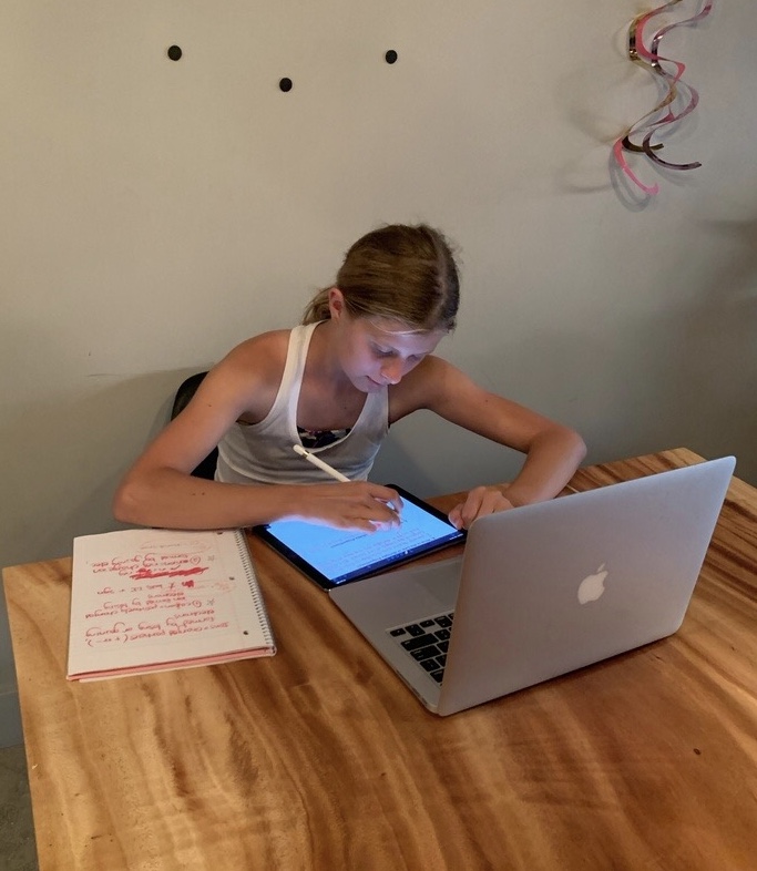 STUDYING+HISTORY+WHILE+LIVING+THROUGH+IT%3A+Sophomore+Willow+Laws+works+on+a+history+worksheet+on+her+iPad+at+home+on+Oct.+13.+Laws%E2%80%99+history+class%2C+taught+by+Justin+Deskovick%2C+is+considered+an+asynchronous+class+where+she+is+given+assignments+and+assessments+to+complete+on+her+own+on+time+and+is+self-paced+for+students+fully+online.+%E2%80%9CI+feel+like+I%E2%80%99ve+gotten+used+to+%5Bonline+school%5D+but+it+is+still+a+little+weird%2C%E2%80%9D+Laws+said.+%E2%80%9CI+only+have+Zoom+classes+for+two+of+my+classes+%5BReligion+and+Spanish%5D+so+I+haven%E2%80%99t+really+seen+who+my+teachers+are+yet.+I+feel+like+I+can+make+it+work+because+all+of+my+teachers+are+always+emailing+me+and+reaching+out+to+me.%E2%80%9D%0A