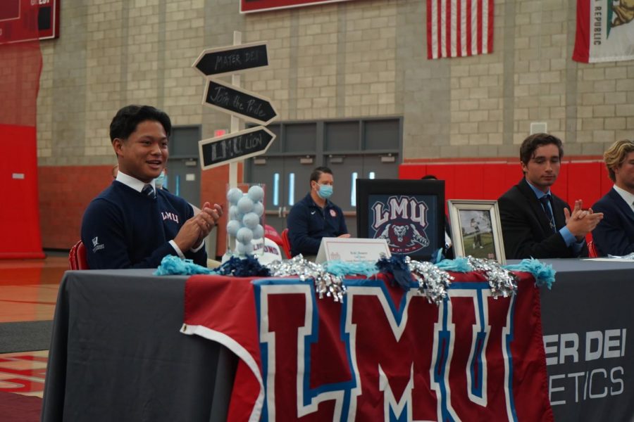 Senior Ryder Henares smiles for the camera from his seat decorated with college gear. Henares committed to play golf for Loyola Marymount University. Ive been waiting for this moment since freshman year and for [National Signing Day] to finally happen. Knowing all my hard work paid off, it was surreal and Im extremely grateful, Henares said.