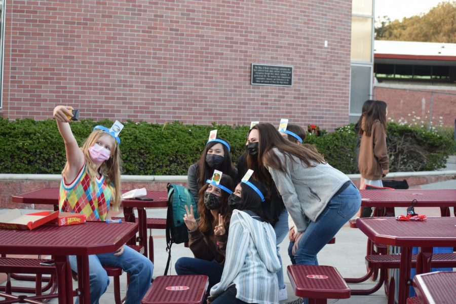 STRIKE A POSE: Freshman Annabelle Cox takes a selfie with her friends after finishing a game of ‘Hedbanz.’ Students were able to meet many new people and hopefully create new friendships in the process. “I loved watching a movie outdoors with my friends,” Cox said. “It was a great experience and I would love to do something like this again.” (Photo courtesy of Emma Califato and Emily Evans)
