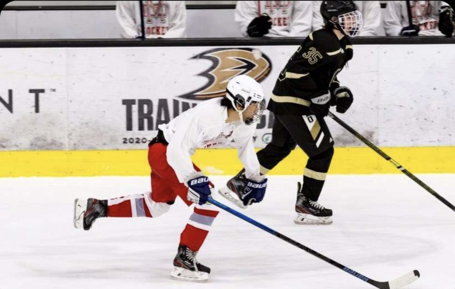 SHREDDING THE ICE: Junior Jeremy Son, an offensive player for the hockey team, skates by an opponent going for the puck. After hours of weekly practice sessions with his teammates and coaches, Son’s skills on the ice have become second-nature. “I like how [coach Lucas Romero] teaches us how to hit and score properly,” Son said. “At this level, we [need to] learn the proper technique to hit right because hitting can be dangerous at times.”  (Photo courtesy of Tej Gahdavi)