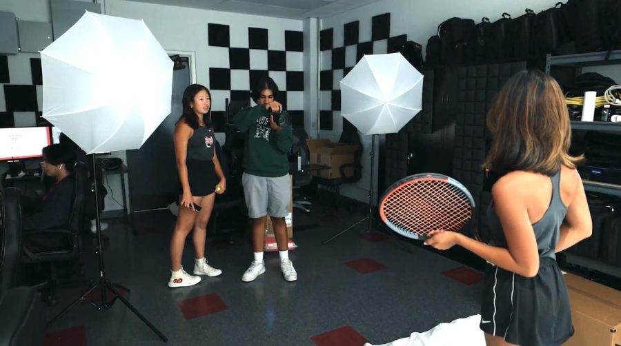 CREATING CONTENT Jai Pandoh and Kara Shen collaborate as Pandoh takes a photo of Sade Calvero in the audio visual room for promotion of the seniors on the Mater Dei Tennis Team: “The skill of collaboration I think is very key to being able to […] [be successful] in what youre doing, to accept peoples not only critiques but also their influences because it can shape your art or your brand,” Shen said.