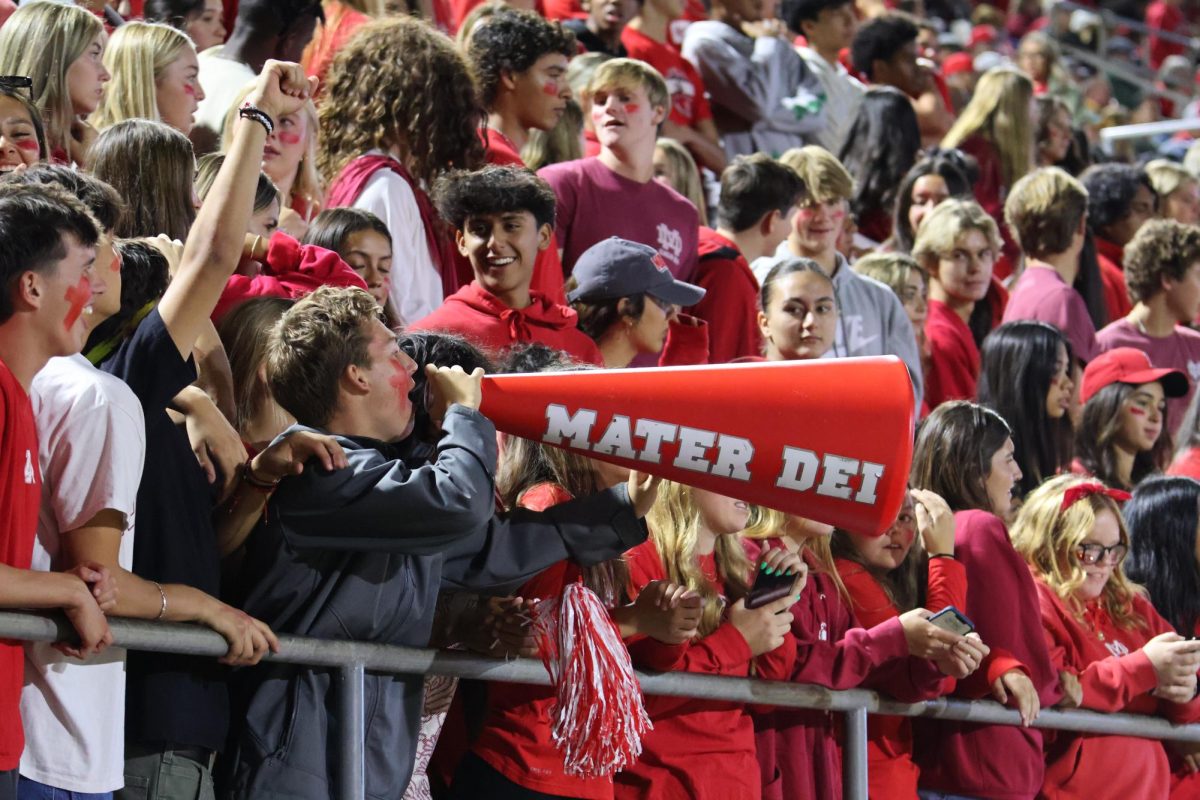 THE MONARCHY: As they pack the Santa Ana Bowl, Mater Dei’s student section continues to make a name for itself during the football game against their long-time rival, Servite. It is through the roaring chants and representing the proud color of the Monarchs that the students prove that the MD spirit runs deep. “[Being a part of] the student section is a way for me to get involved and show my love for Mater Dei. I get so excited to see my friends and show support for the teams,” Junior Grace Henze said.