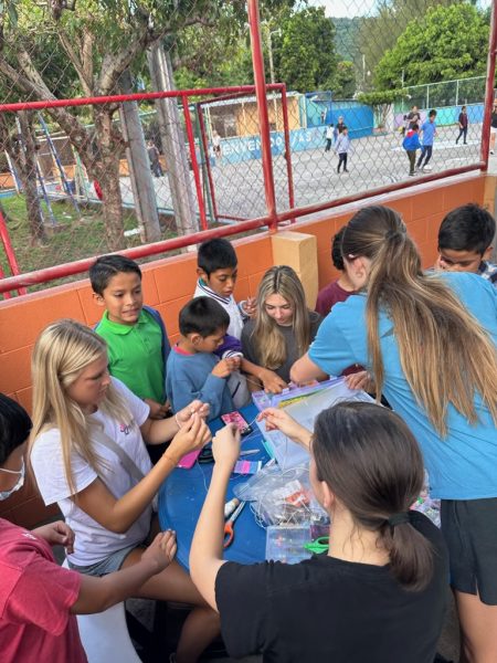 TOKENS OF FRIENDSHIP: Junior Lydia Lea visits an all boy orphanage in El Salvador and builds new friendships at the arts and crafts table. As Lea interacted with the young boys and girls throughout her trip, she created friendship bracelets as a symbol of family. By doing so, Lea modeled the spirit of goodness for the masses of neglected children. 