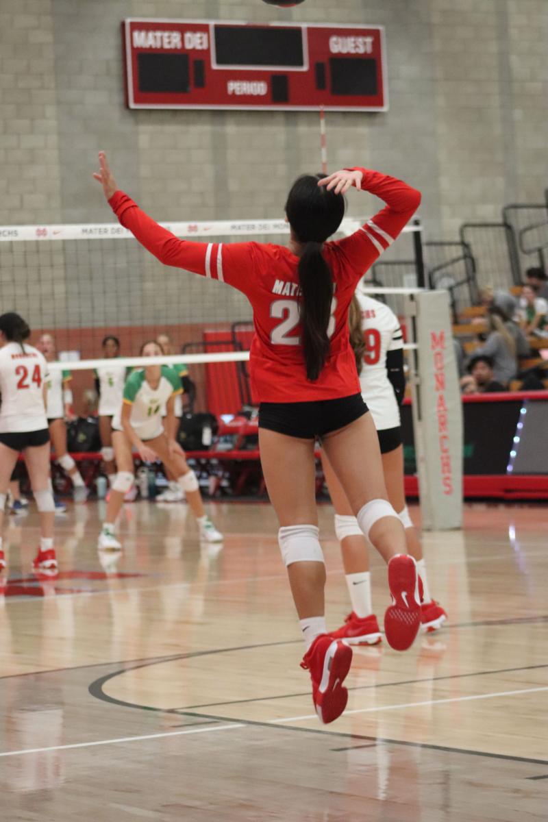 TRYOUT TIME: Junior Chloe Nguyen begins to serve a volleyball during 2024 tryouts. Tryouts offer her a chance to form new connections with potential future teammates, and show improvement from the previous year. Mater Dei athletes bring dedication and focus to team tryouts, showing their months of preparation and practice. “It’s a great way to destress after school, and it’s a lot of fun.” Photos by sophomore Staff Member of CROWN Yearbook Yeretzi Rodriguez.
