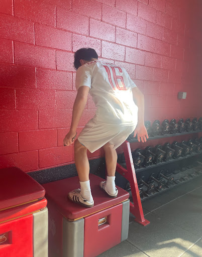 BODYBUILDING ACTIONS:  Freshman Presley Patrick does a box jump in the weight room during his team’s designated weight time. This is one of the many exercises that are available in the weight room in order to build strength within athletes. “[The weight room] brings everyone together and the energy is massive,” Patrick said. Photo illustration by 