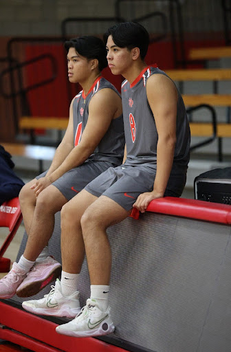 COMPLIMENTARY COMPANIONS Seniors Niko Manapat and Josh Sumbong sit together on the bench after working hard together and constantly lifting their teammates up. Sharing a nonstop train of compliments helps them to make sure they feel confident even during high pressure moments. “I keep myself and others motivated by keeping a positive mindset and focusing on the next play instead of focusing on past mistakes,” senior Niko Manapat said. Photo courtesy of 