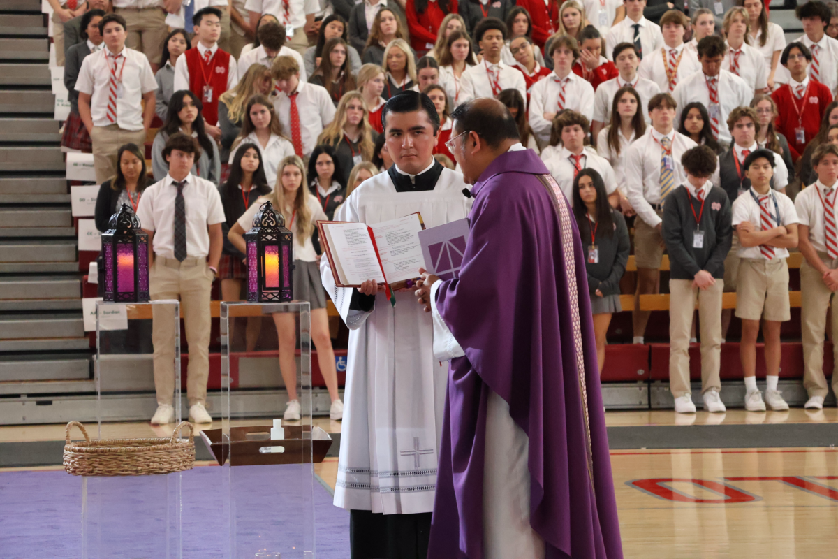 LIVING OUT THE WORD Father Mark Cruz reads the Liturgy of the Word during Mater Dei’s 2024 Ash Wednesday Mass. This allowed him to share the word of God to the student body, helping students to prepare for the upcoming Lenten season. The Monarch community participates in the Mass, growing in honor, glory, and love. “Ash Wednesday reminds me that life is fleeting, but faith is eternal,” senior Duong Nguyen said. “Today, I walk forward with gratitude, seeking renewal, growth, and a heart closer to God.” Photo by Angelin Tran.