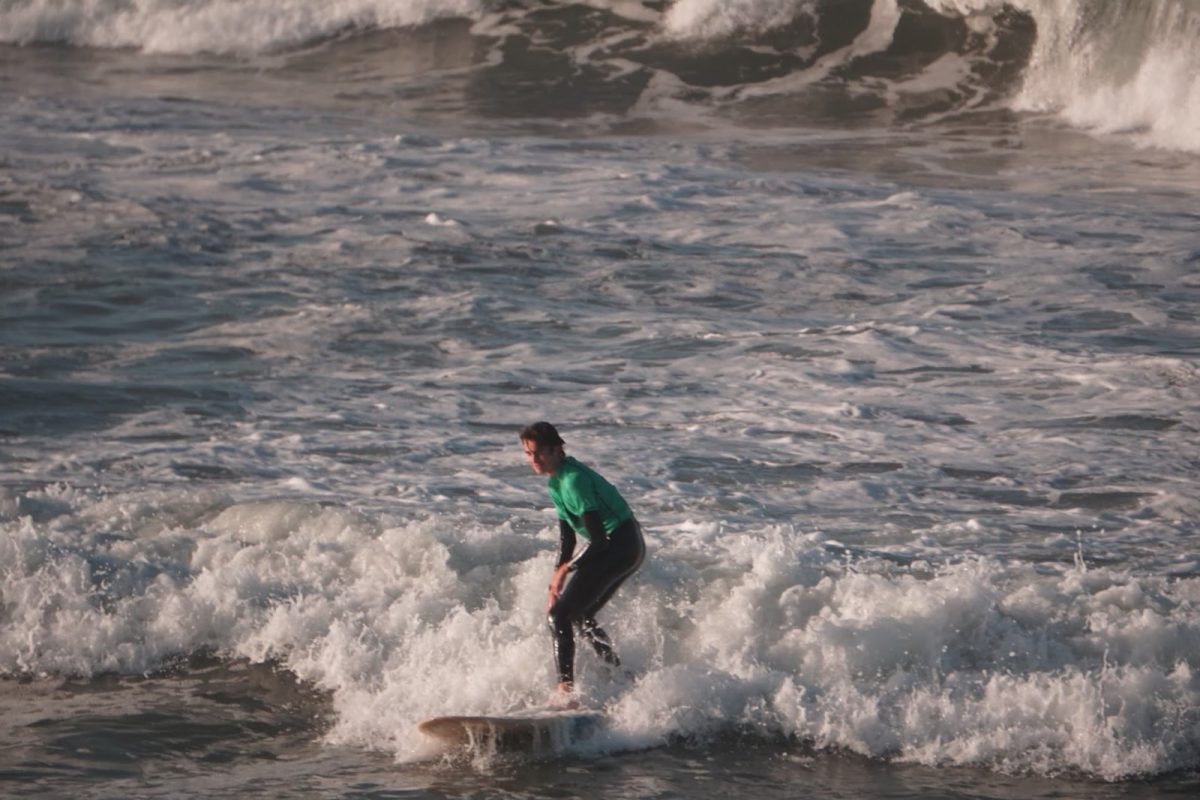 SHREDDING THE WAVES Junior Diego Villa rides a wave he caught during a team practice. Surfing a wave requires a lot of practice, and the Mater Dei surf team offers ample time for members to perfect their technique out at sea. “The first time I surfed was when I was around nine or ten, but I never surfed consistently,” Villa said. “Then freshman year, I joined the surf team and decided to get a lot more consistent. That's when I really started to get better at surfing.” Photo illustration by Kenny Smith.
