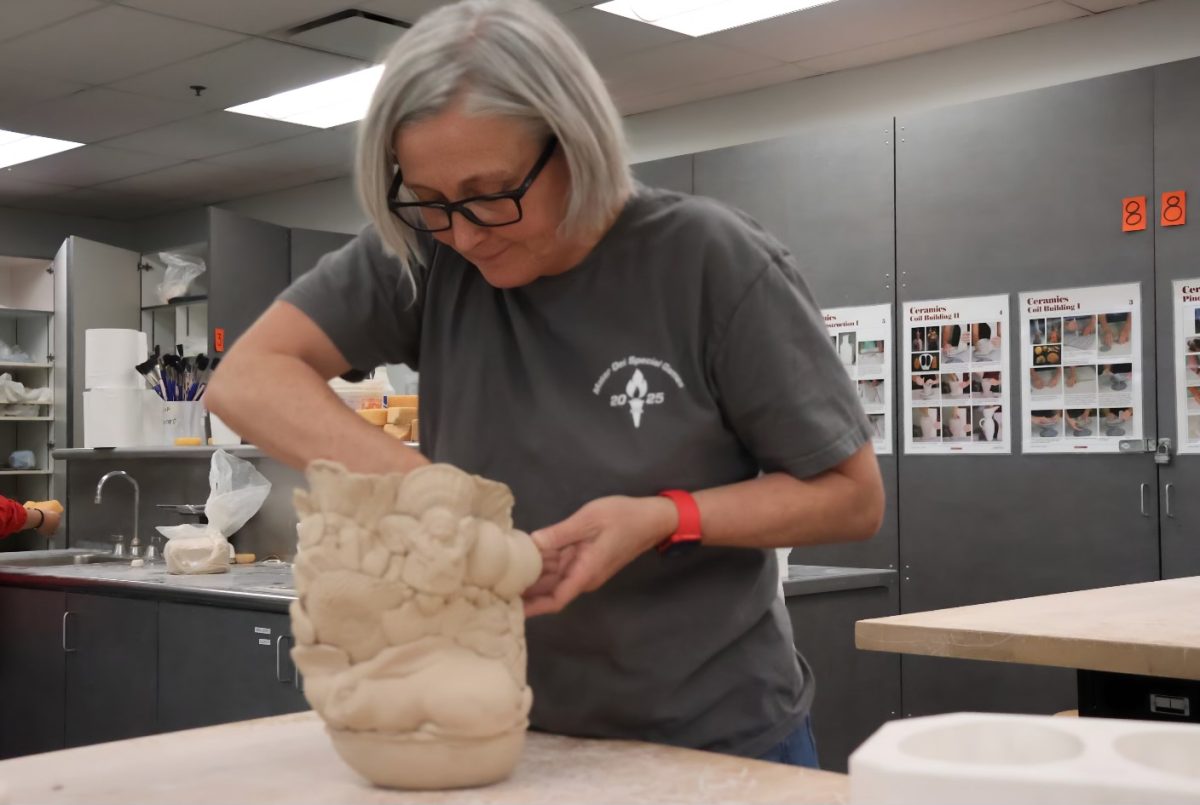 MELTICULOUS AP MARATHONS Visual Arts teacher and NAHS moderator Caroline Davis works on a sculpture as an example for students preparing for the AP 3D Art and Design portfolio deadline on May 8. Teaching at Mater Dei High School since 2004, Davis has continuously refined her instructional strategies to help students succeed on the AP Exam. By analyzing AP strategies from previous years, she has worked to turn past weaknesses into strengths. “In AP Art, students need to think about how their work is presented and written about, not just how it looks,” Davis said. “Since readers spend only a few seconds per image, I have to guide my students on how to clearly communicate the idea, and the commentary in order to let judges cover the insight of their pieces for a short period of time.” Photo by Jennie Nguyen.